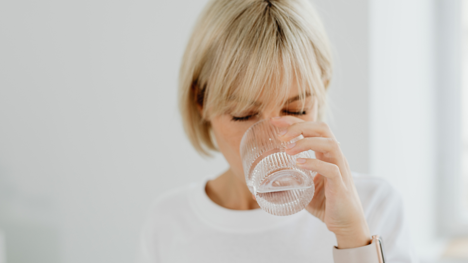 Adult drinking water from a glass, representing swallowing assessment and dysphagia support across the lifespan.