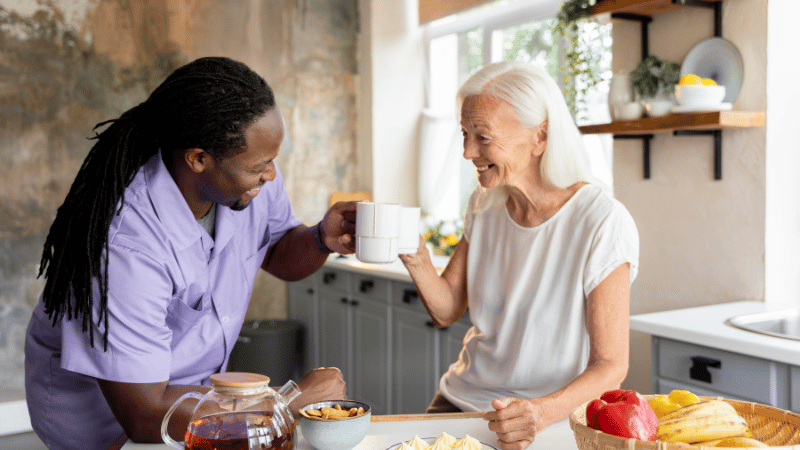 Two people sharing a calm moment in a kitchen, representing safer, more predictable mealtime environments.